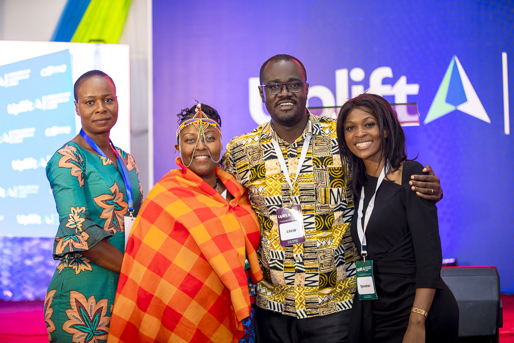 A young person sits on wooden stairs with an open book, reading or studying.